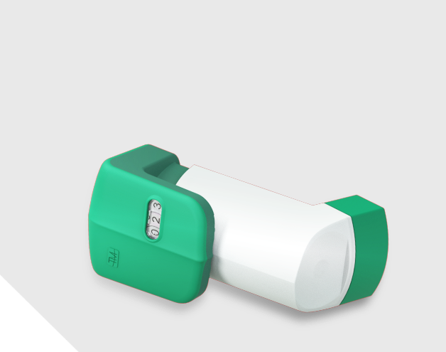 A copd or asthma inhaler with a count-down mechanism is placed sideways over a surface. Its dose window indicates the number 023.