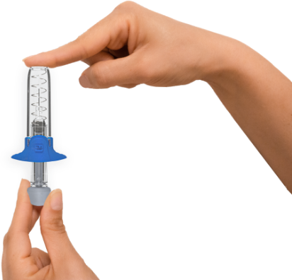 A tip-up auto-disable syringe being hold by one hand. The other place its index finger against the activated safety needle shield.
