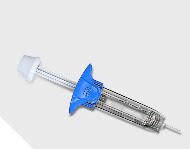 A new and uncapped glass syringe within a passive safety device placed on a flat surface.